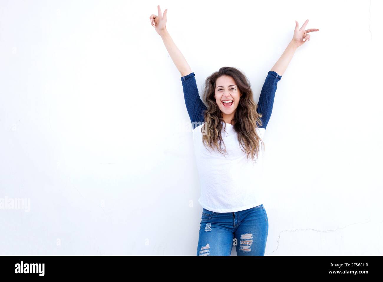 Front portrait of young laughing woman arms raised Stock Photo - Alamy