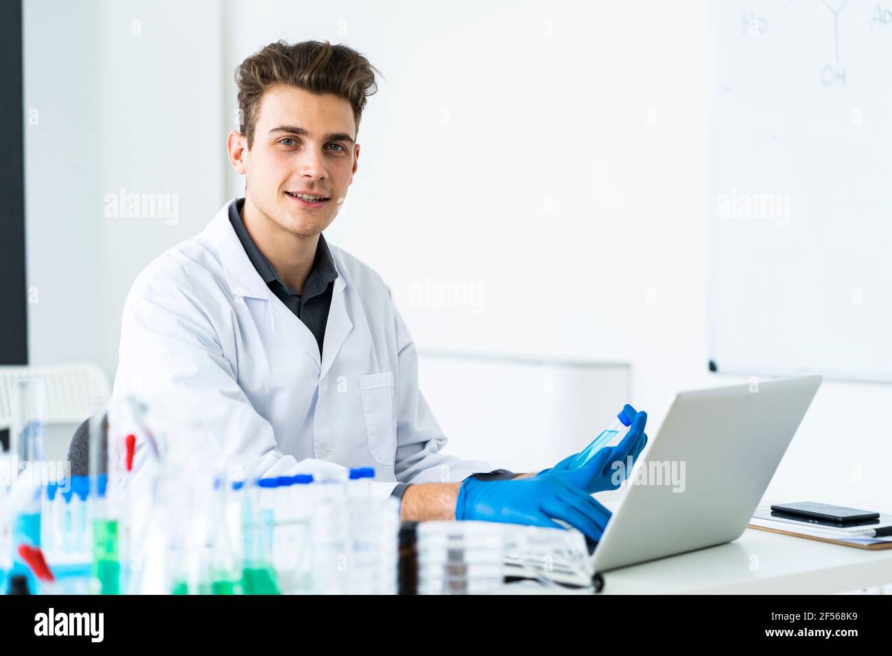Male scientist using laptop while working in laboratory Stock Photo
