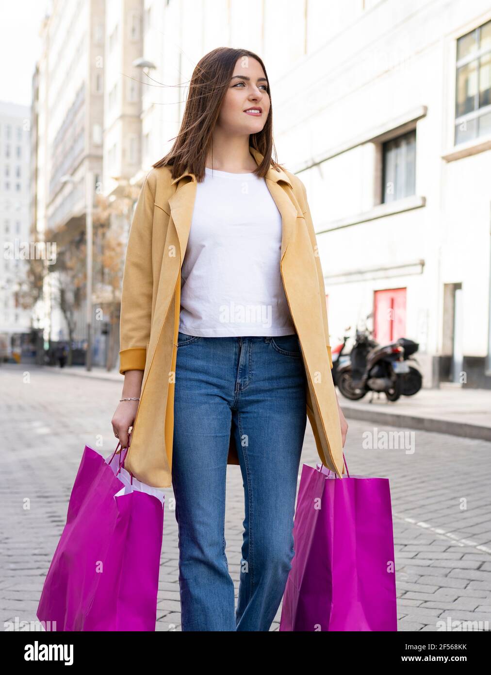Women walking away carrying shopping bags hi-res stock photography and ...