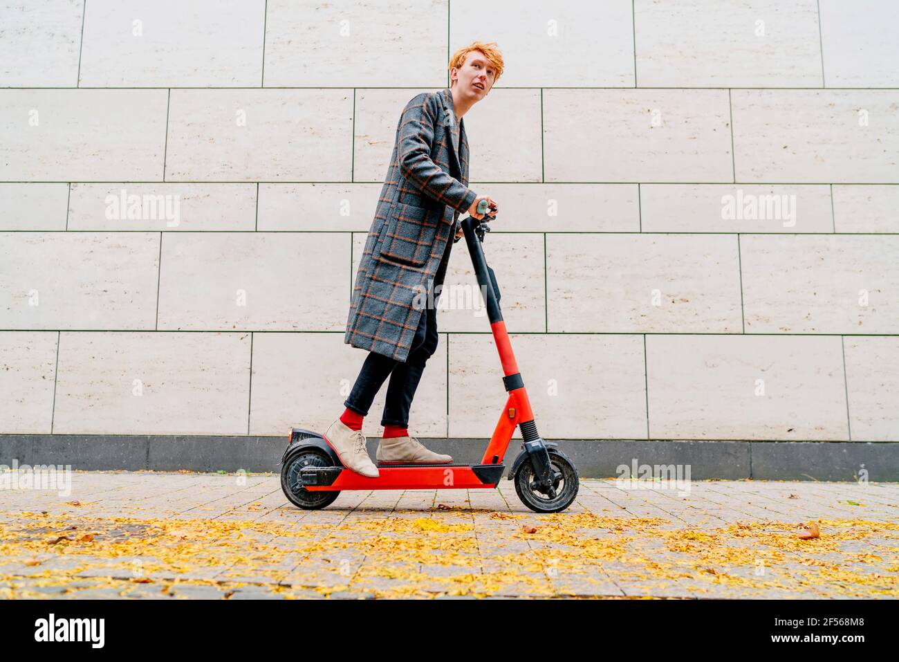 Man on a push scooter hi-res stock photography and images - Alamy