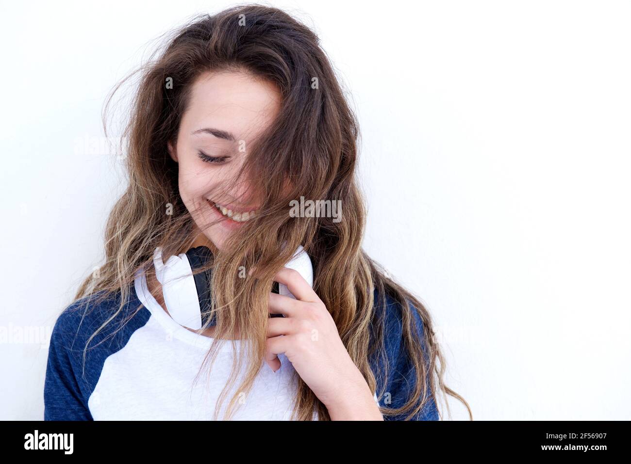 Close up portrait of beautiful young woman with headphones laughing ...