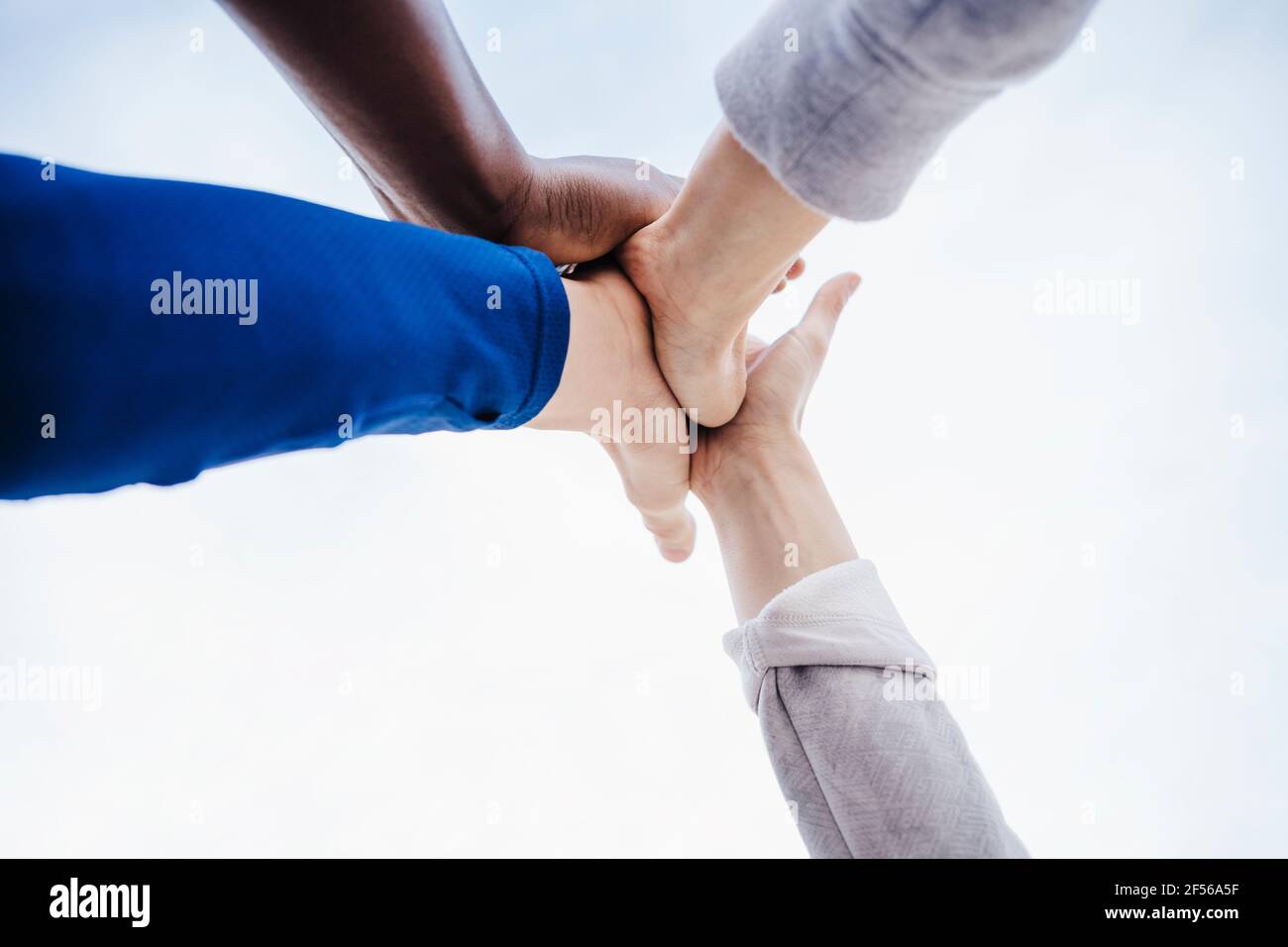 Multi-ethnic group of friends giving high-five Stock Photo