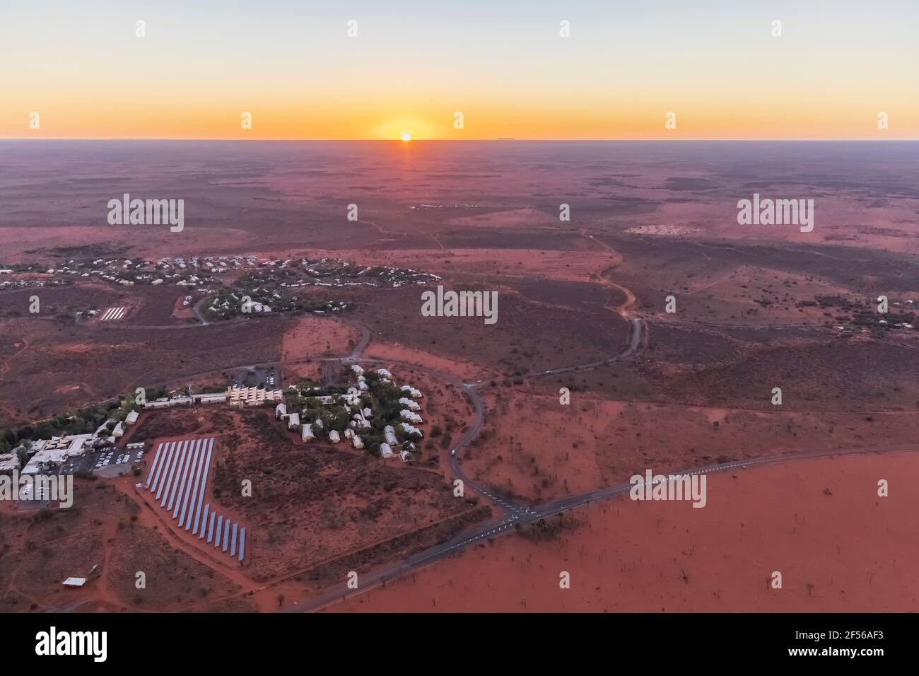 Australia, Northern Territory, Yulara, Aerial view of desert town in Uluru-Kata Tjuta National Park at sunrise Stock Photo