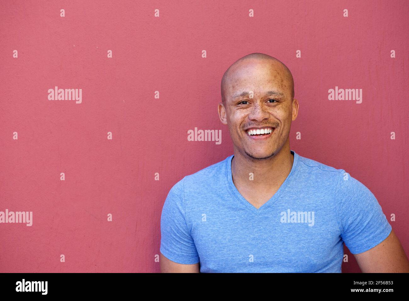 Close up portrait of handsome african american man smiling against red ...