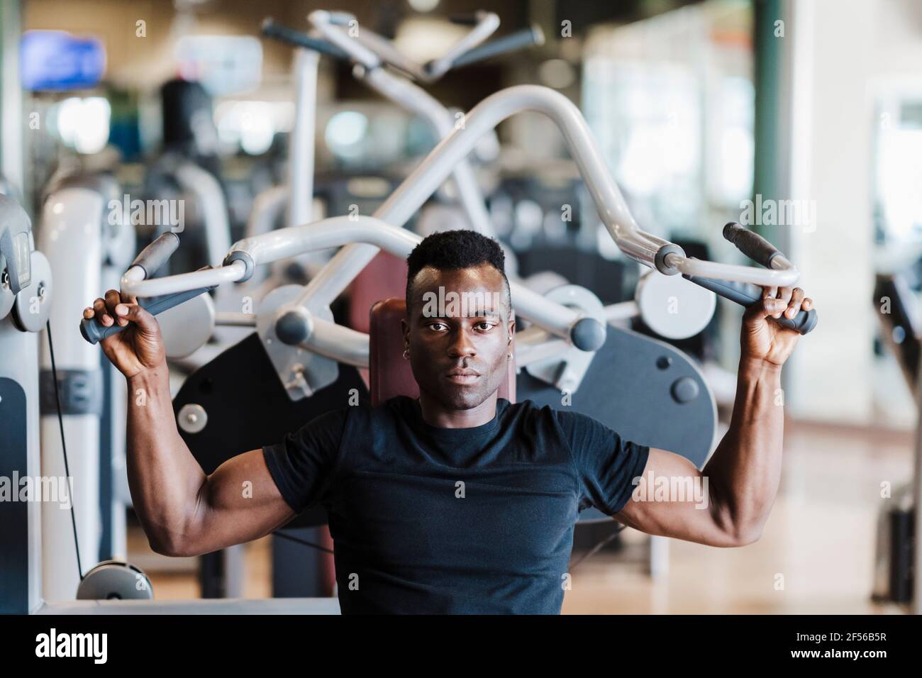 Young athlete exercising strength training in health club Stock Photo