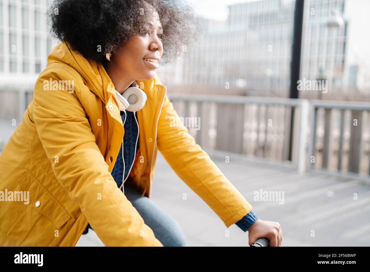 Young woman cycling on footpath Stock Photo