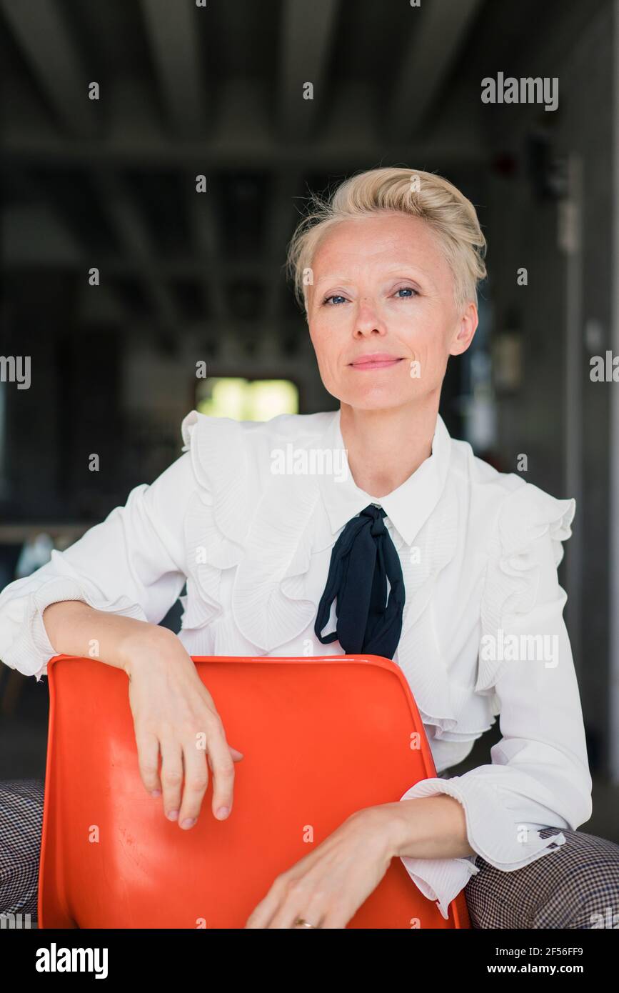 Mature woman sitting on chair hi-res stock photography and images - Alamy