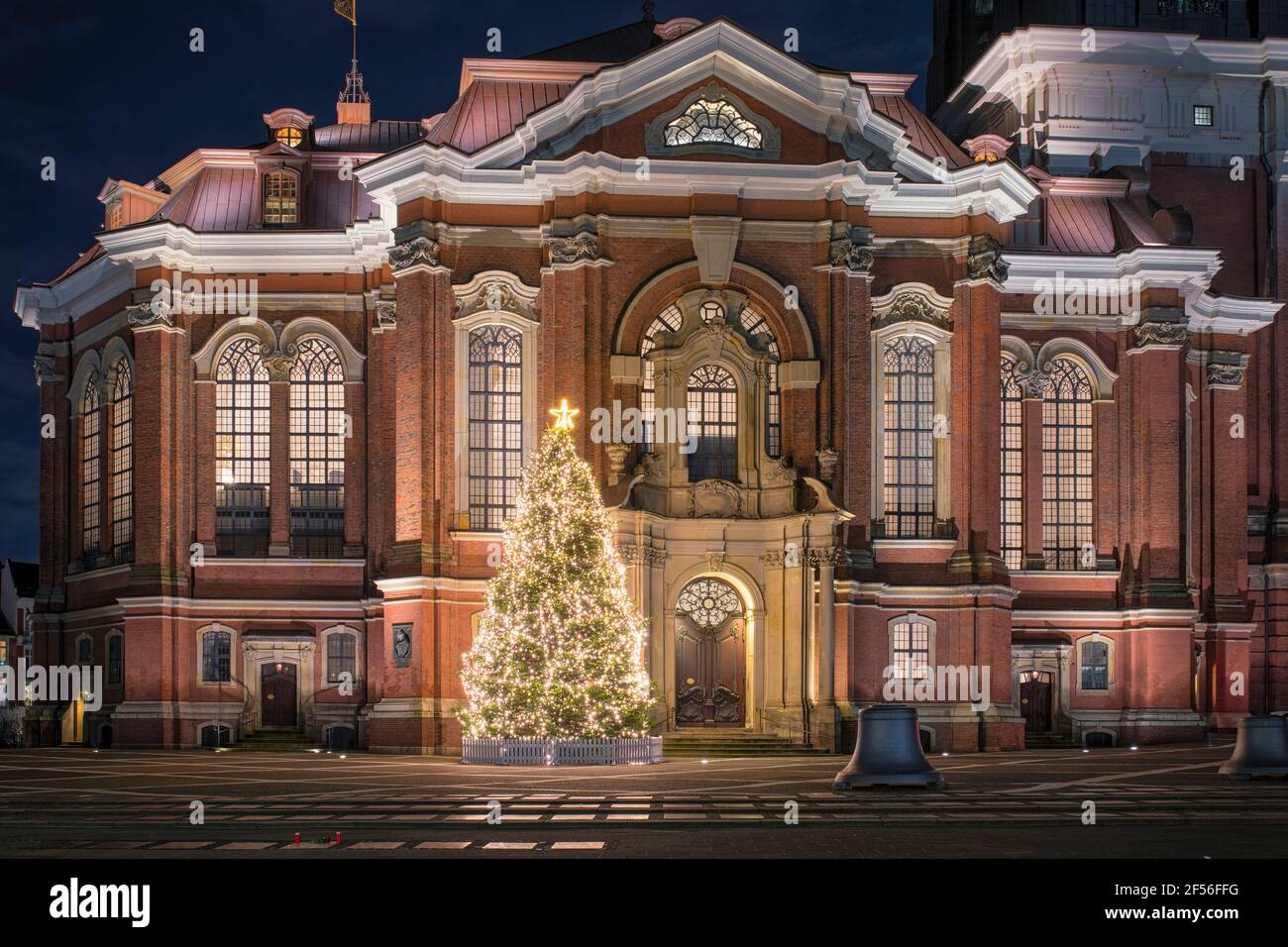 Germany, Hamburg, Christmas tree glowing in front of Saint Michaels Church at night Stock Photo