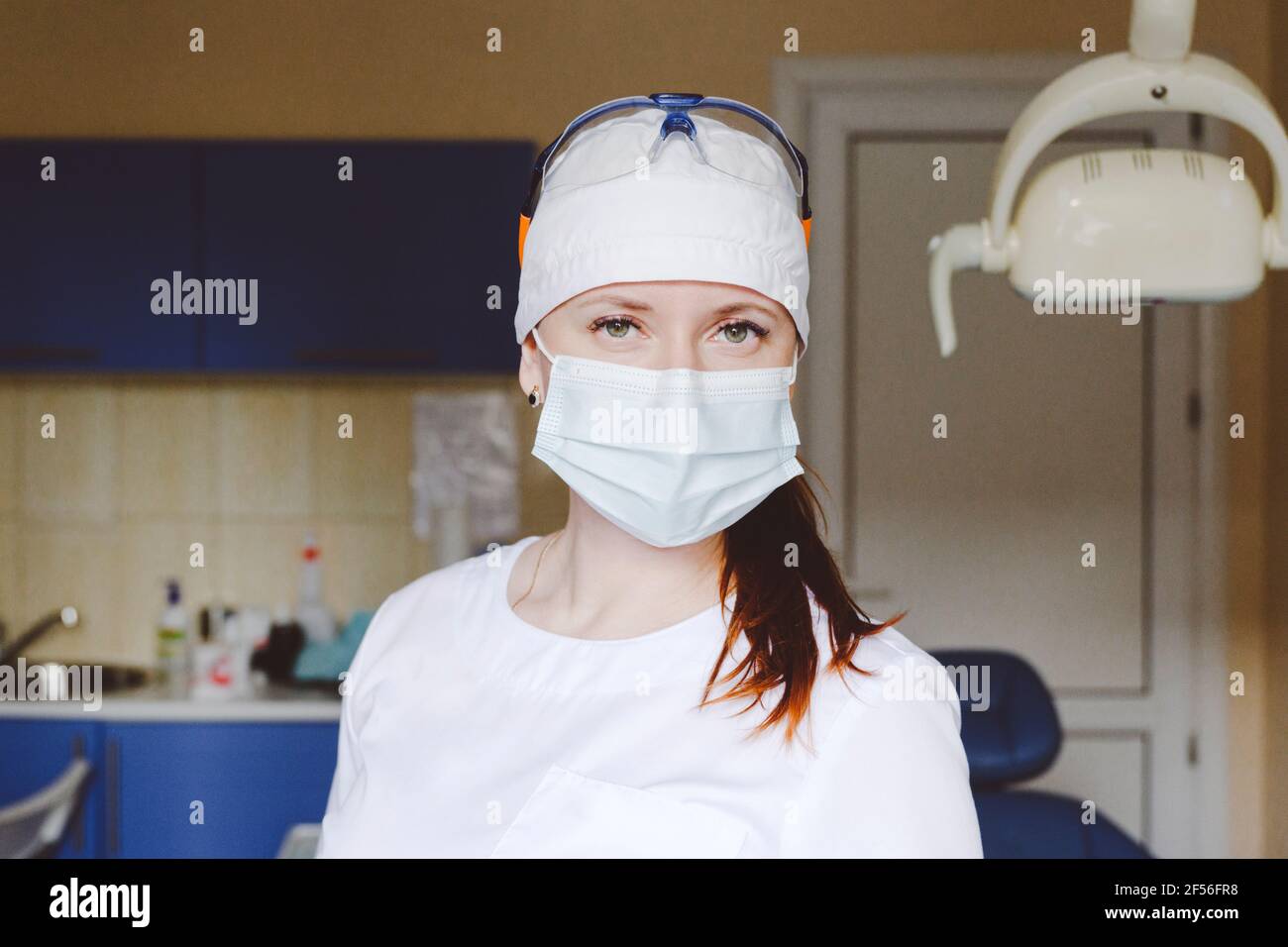 Portrait of female dentist wearing protective face mask Stock Photo