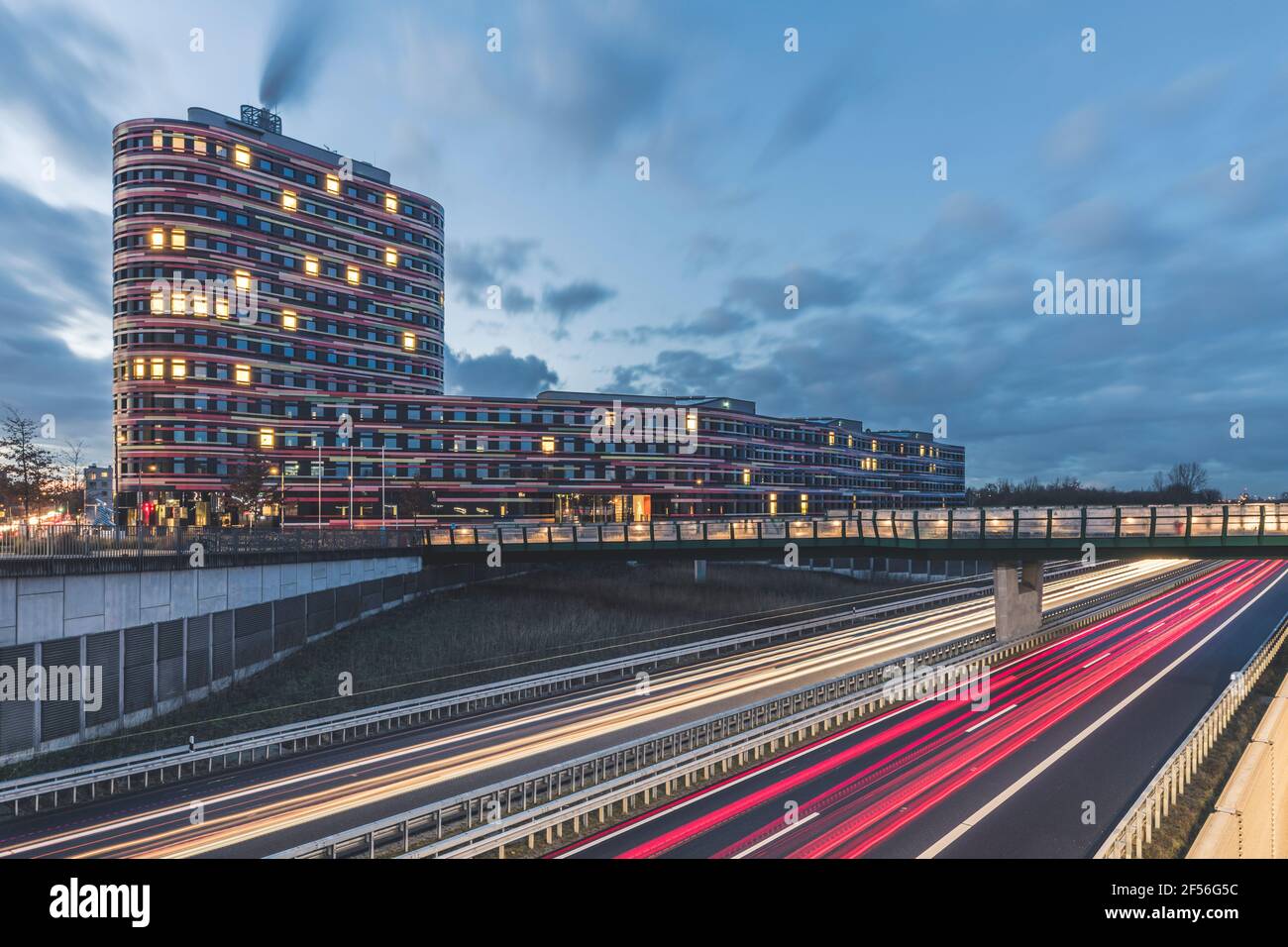 Germany, Hamburg, Amt fur Umwelt building exterior illuminated at dawn Stock Photo