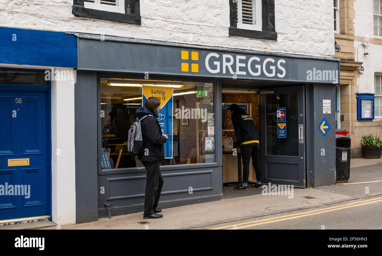 People queueing outside Greggs bakery shop during pandemic, High Street, North Berwick, East Lothian, Scotland, UK Stock Photo