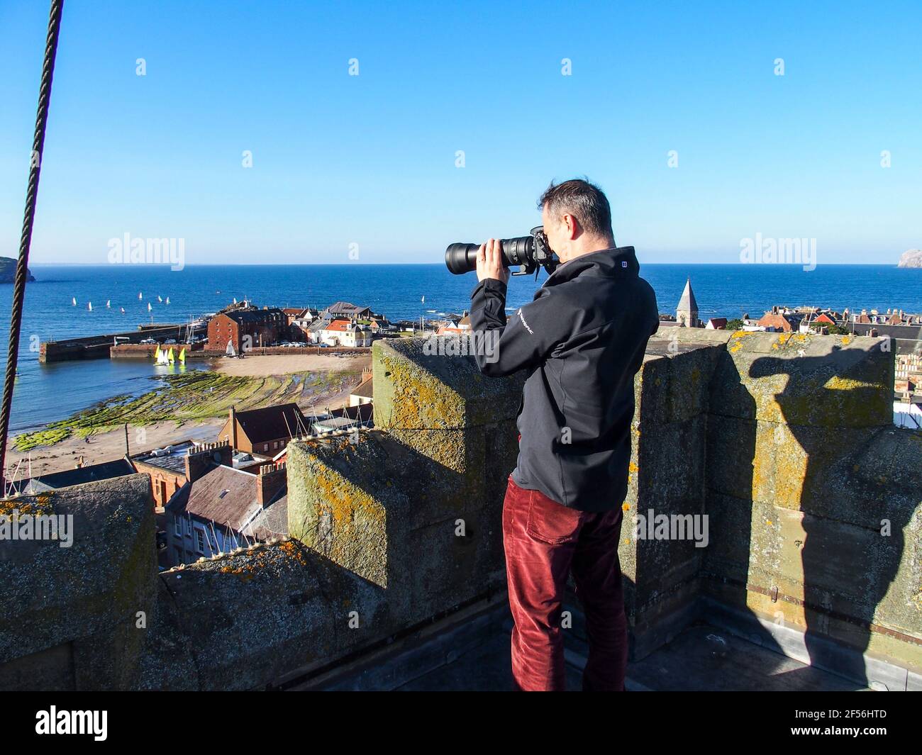 Man taking photographs from top of St Andrew Blackadder Church tower