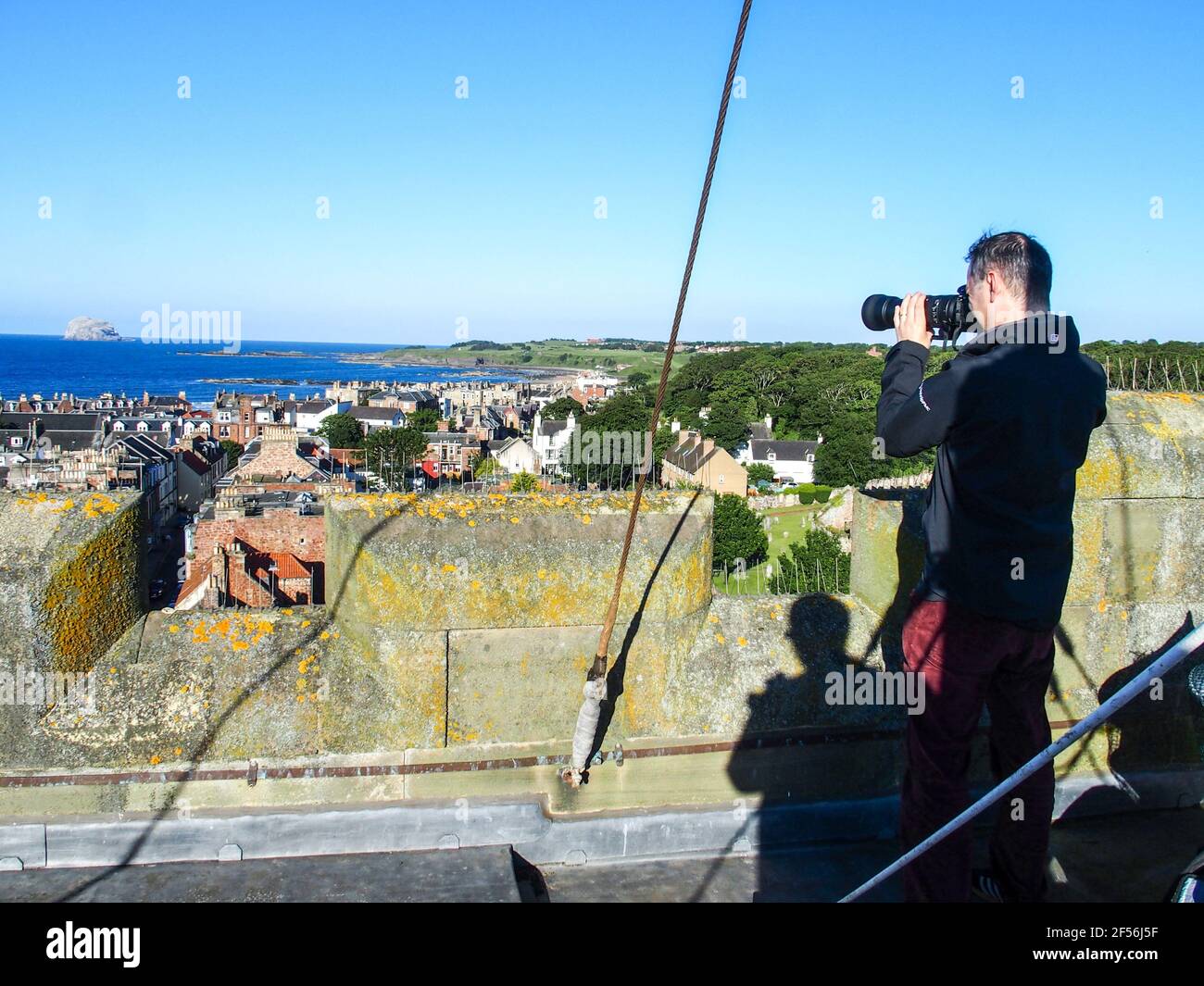 Man taking photographs from top of St Andrew Blackadder Church tower