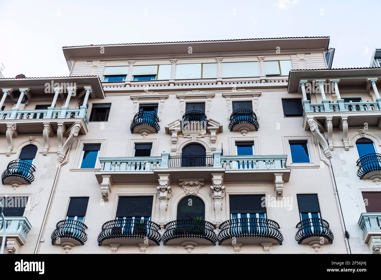 Facade of an old classic building with with semicircular balconies of ...