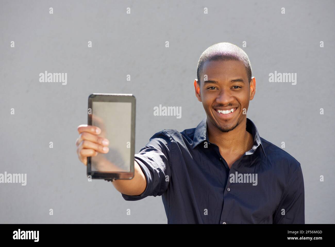 Portrait of young african man holding digital tablet Stock Photo - Alamy