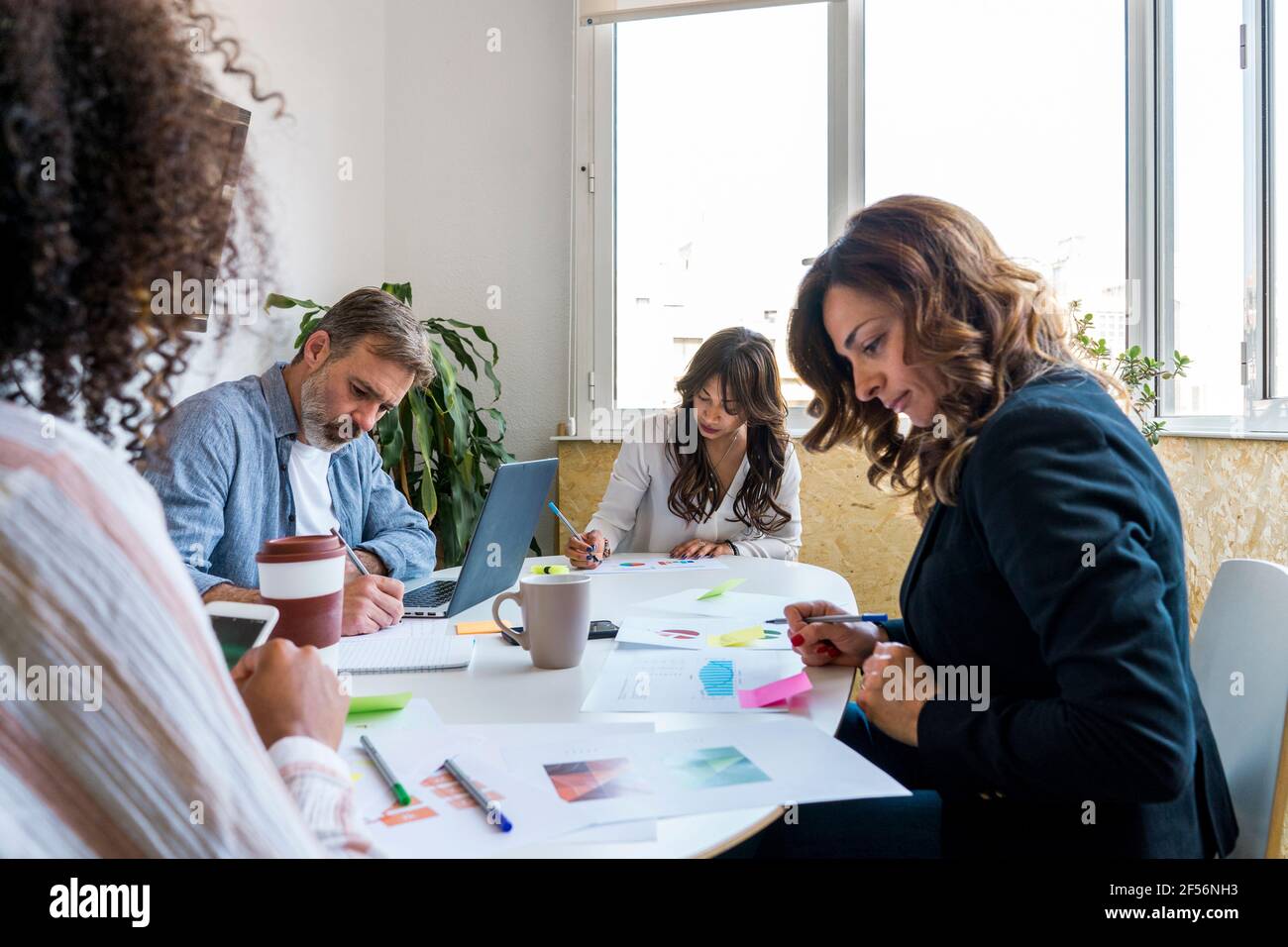 Multi-ethnic coworkers making strategy in office Stock Photo
