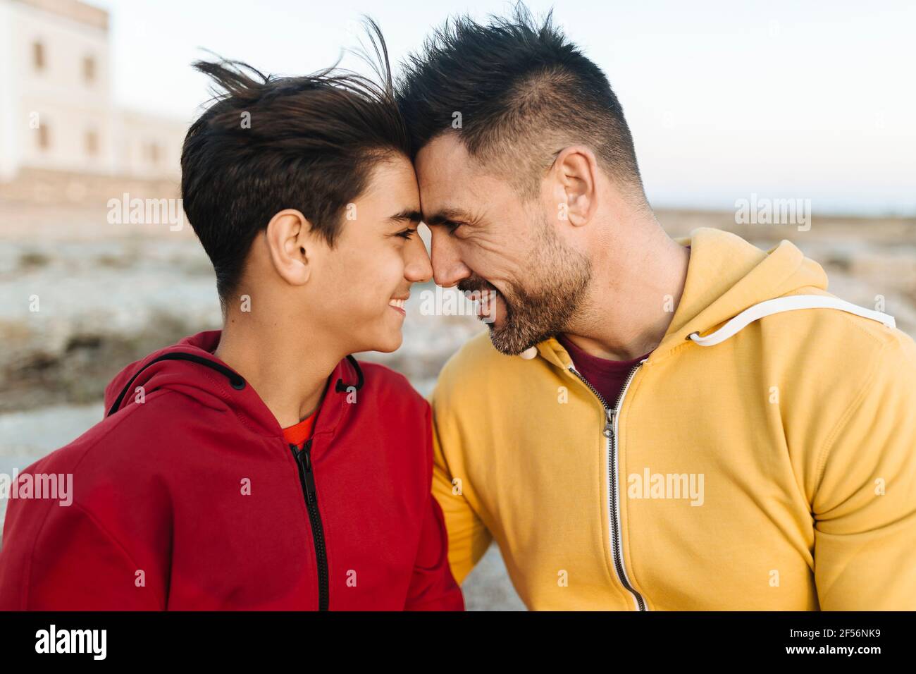Smiling father and son touching forehead Stock Photo - Alamy