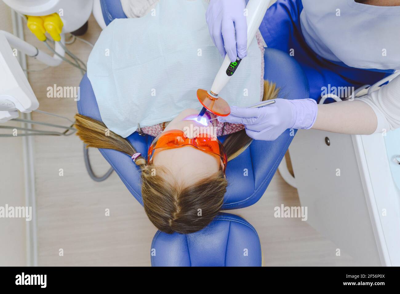 Little girl lying in dentists chair during dental exam Stock Photo