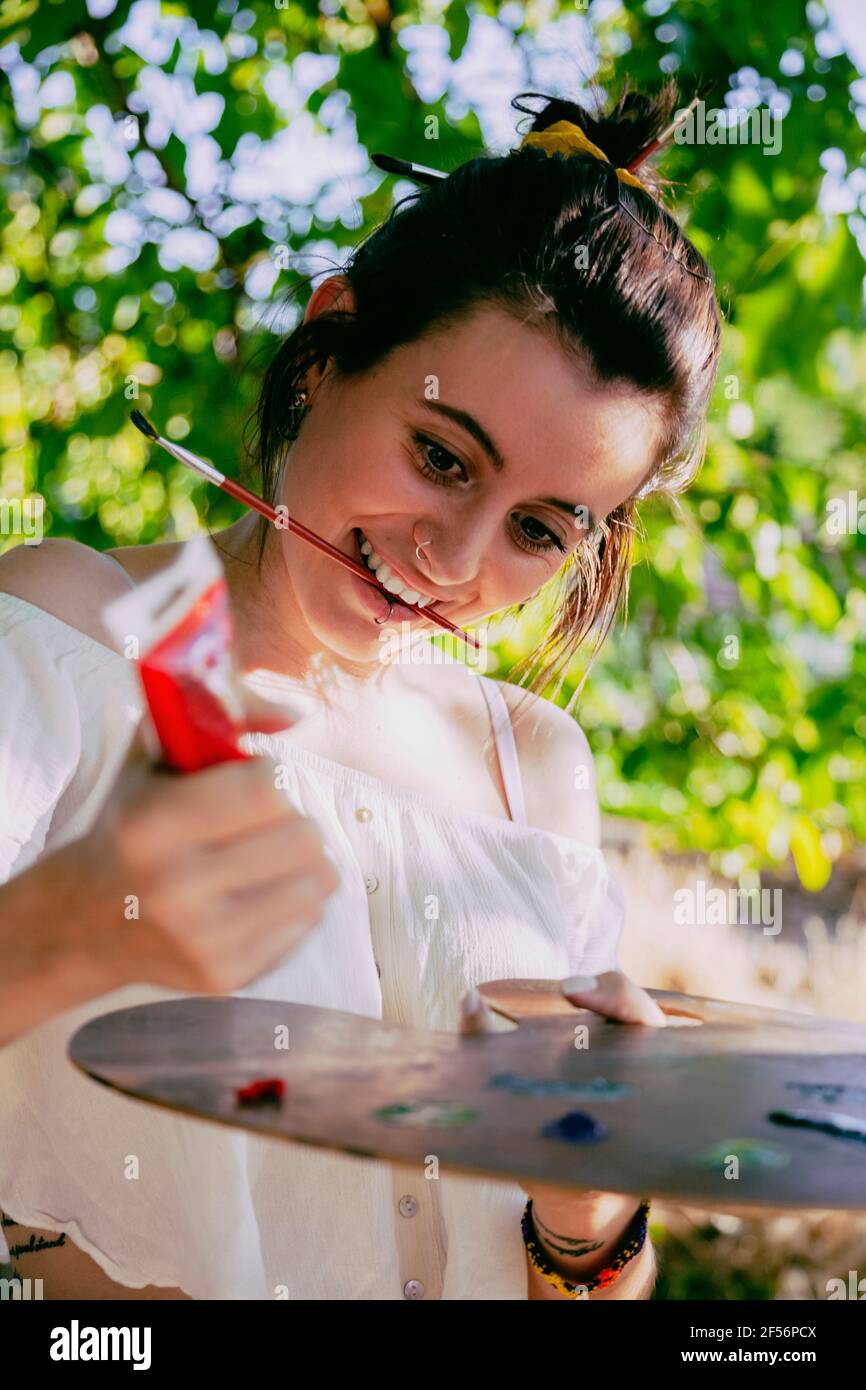 Young woman artist with paint and palette Stock Photo