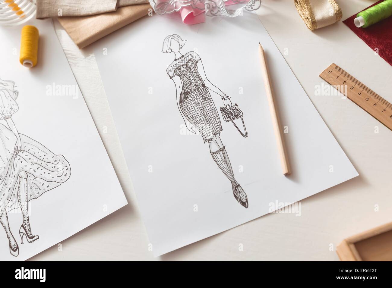 Sketch of women's fashionable clothes drawn on paper by the designer ...