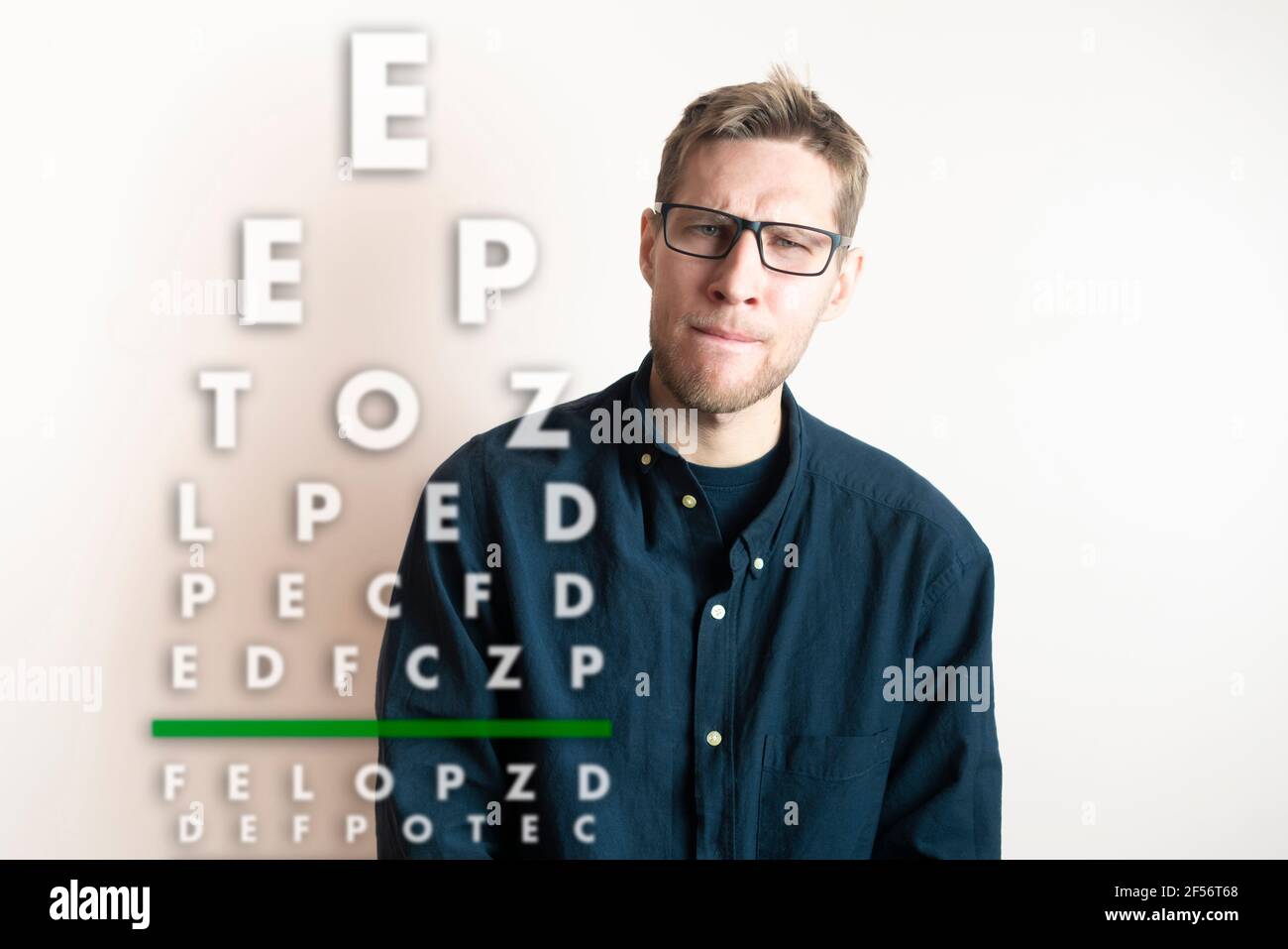 a young man check the eyesight vision, examine the health with test letters chart Stock Photo