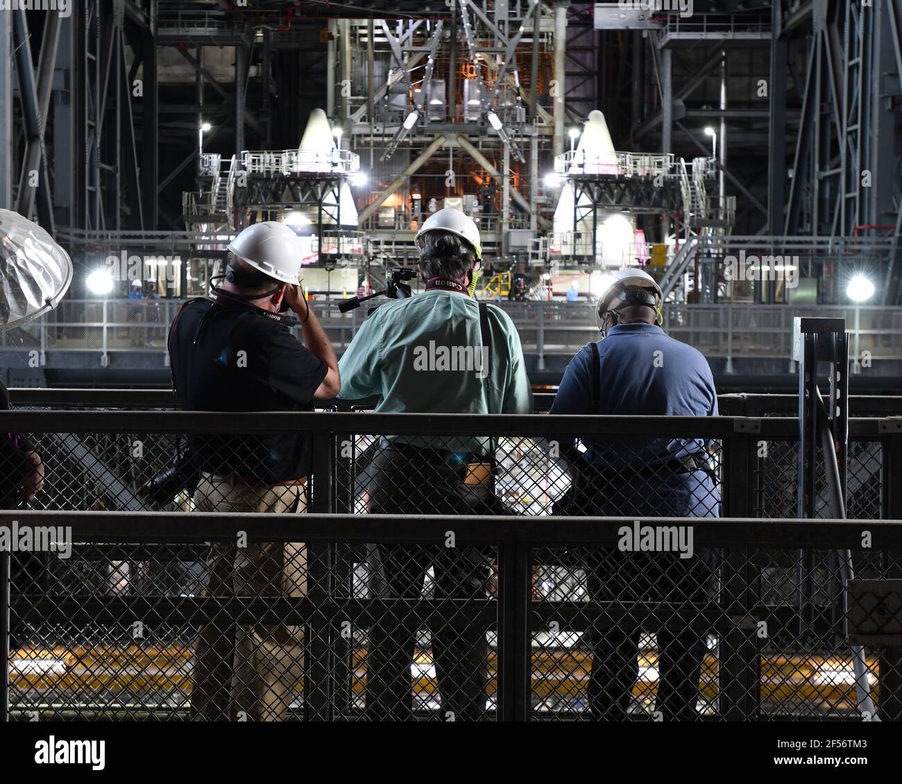 Kennedy Space Center, United States. 24th Mar, 2021. Inside the Vehicle Assembly Building, photographers take images of the stacked solid rocket boosters of NASA's Space Launch System (SLS) rocket at the Kennedy Space Center, Florida on Wednesday, March 24, 2021. Photo by Joe Marino/UPI Credit: UPI/Alamy Live News Stock Photo