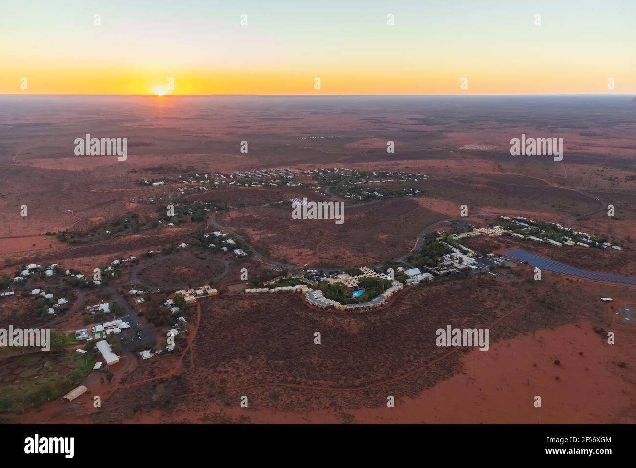 Australia, Northern Territory, Yulara, Aerial view of desert town in Uluru-Kata Tjuta National Park at sunrise Stock Photo
