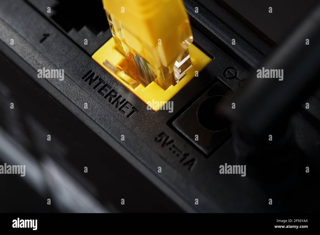 Wireless modem router with yellow cable and LAN port for connection on