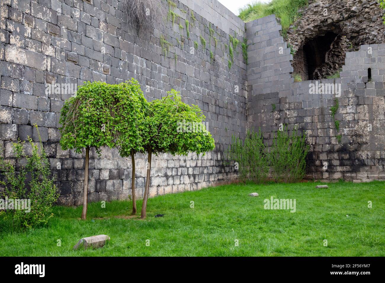 Old City Walls in the city of Diyarbakir, Turkey. People walk around the city walls and rest. Stock Photo