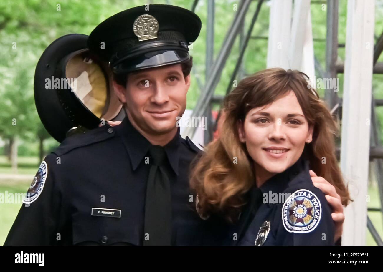 USA. Steve Guttenberg and Kim Cattrall in a scene the (C)Warner Bros. film: Police  Academy (1984). Plot: A group of good-hearted, but incompetent misfits  enter the police academy, but the instructors there