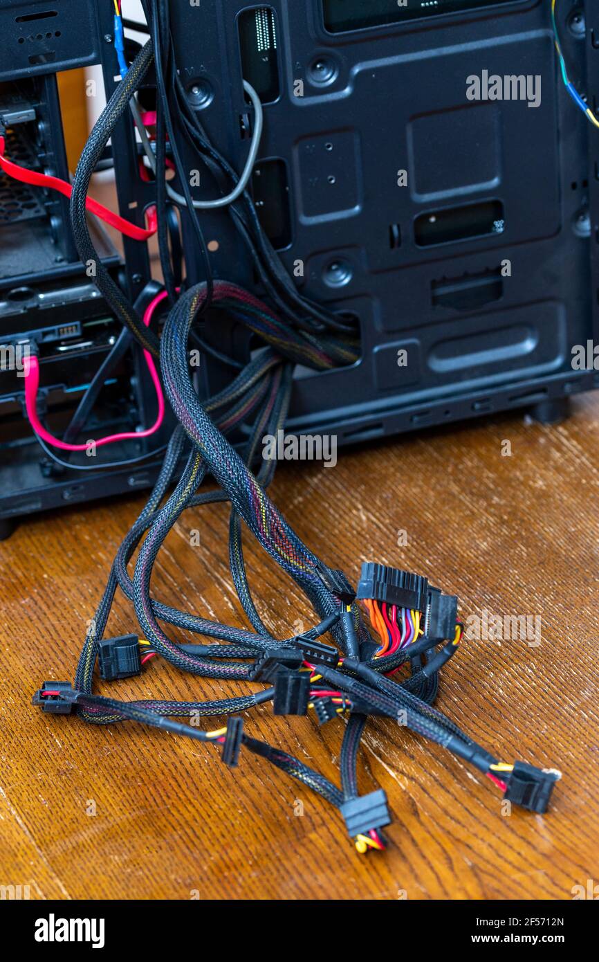 bunch of computer power supply wires sticking out from opened black pc
