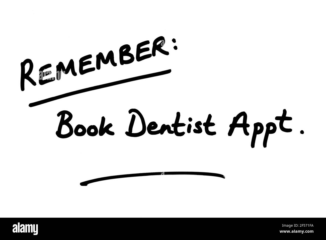 Remember - Book Dentist Appt, handwritten on a white background. Stock Photo