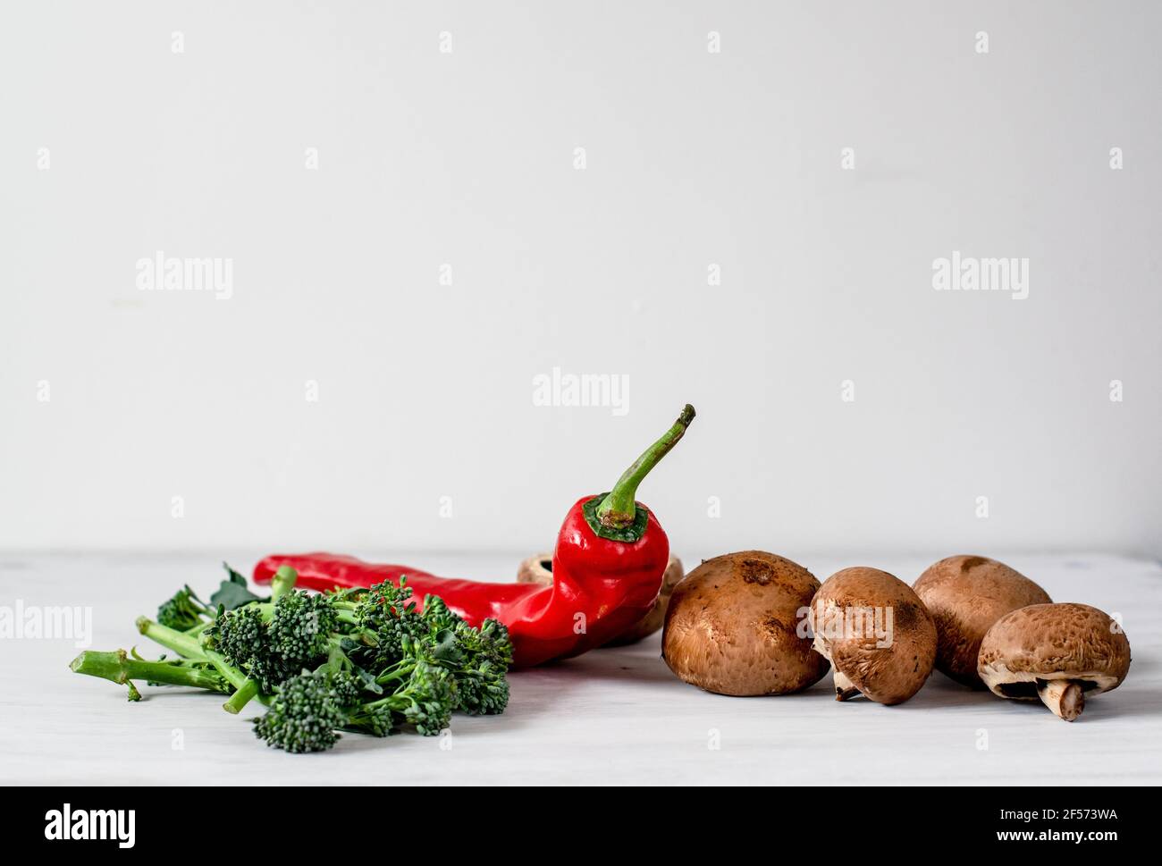 An Organic Red Romano Pepper with Tenderstem broccoli and chesnut mushrooms Stock Photo