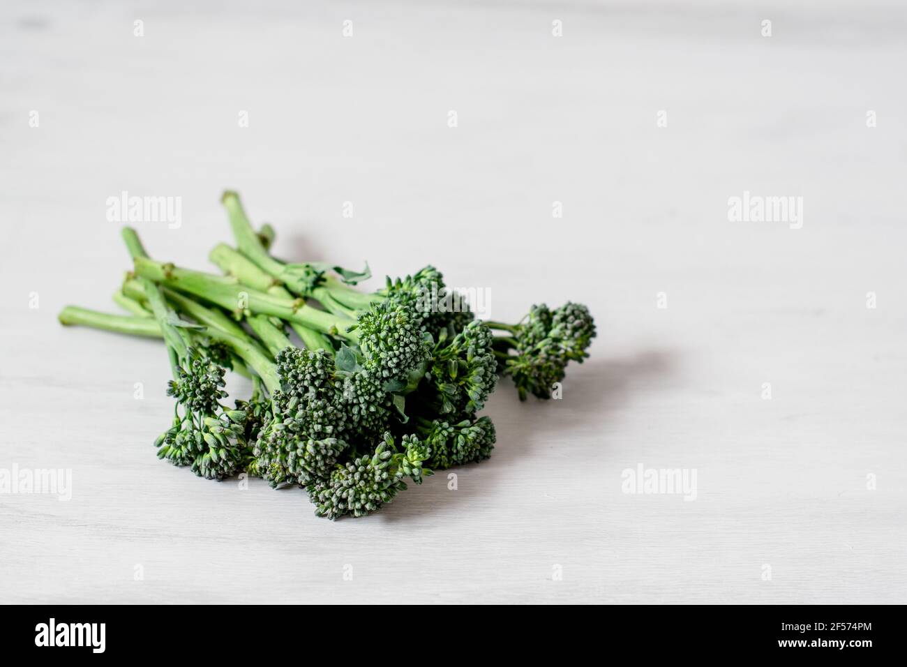 Spring Vegetable - Spears of Organic Tenderstem Broccoli against a plain neutral background Stock Photo