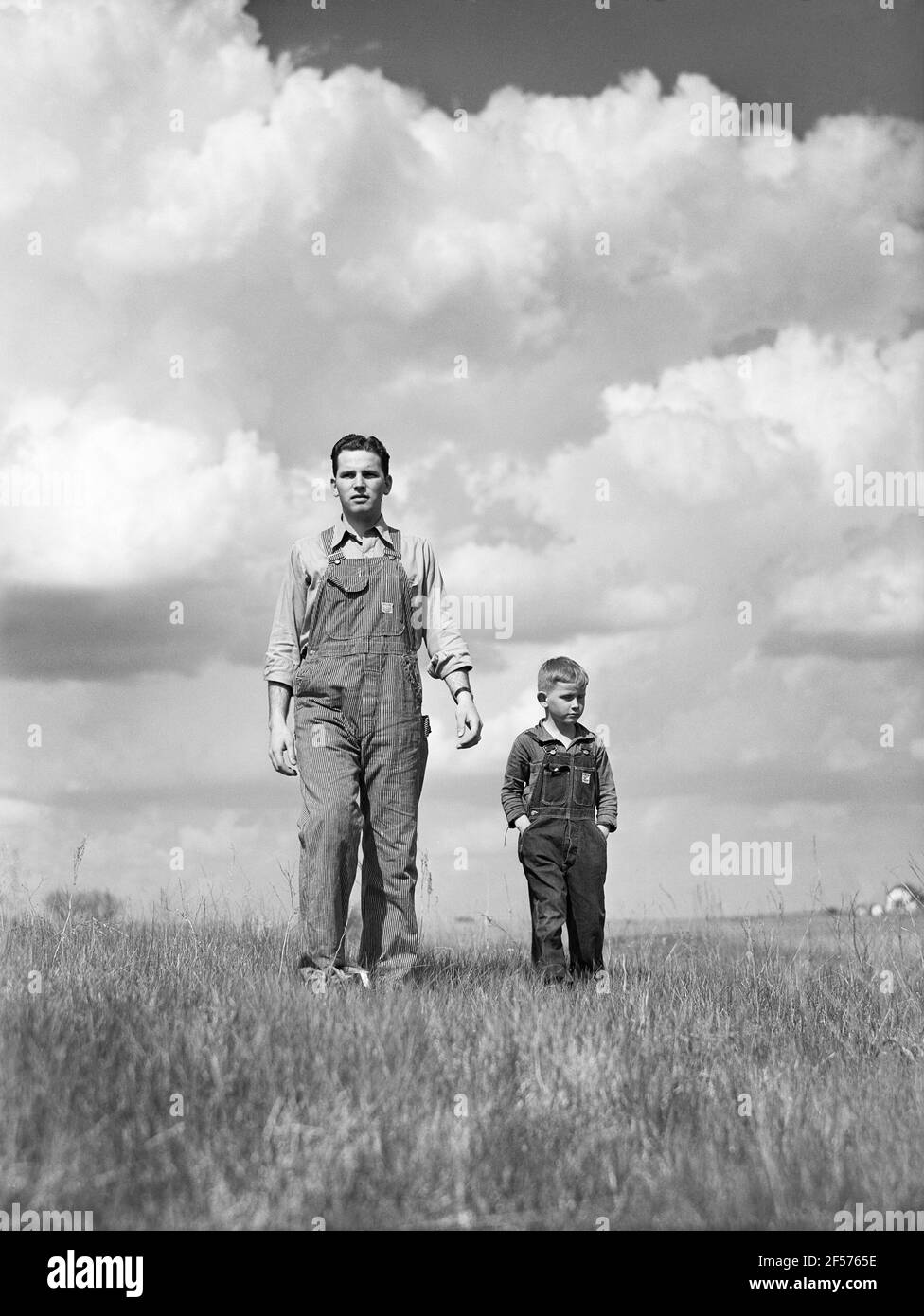 youngest brother taking Gene Cooper, student at Iowa State College, on tour of Farm, near Ames, Iowa, USA, Jack Delano, U.S. Farm Security Administration, May 1942 Stock Photo