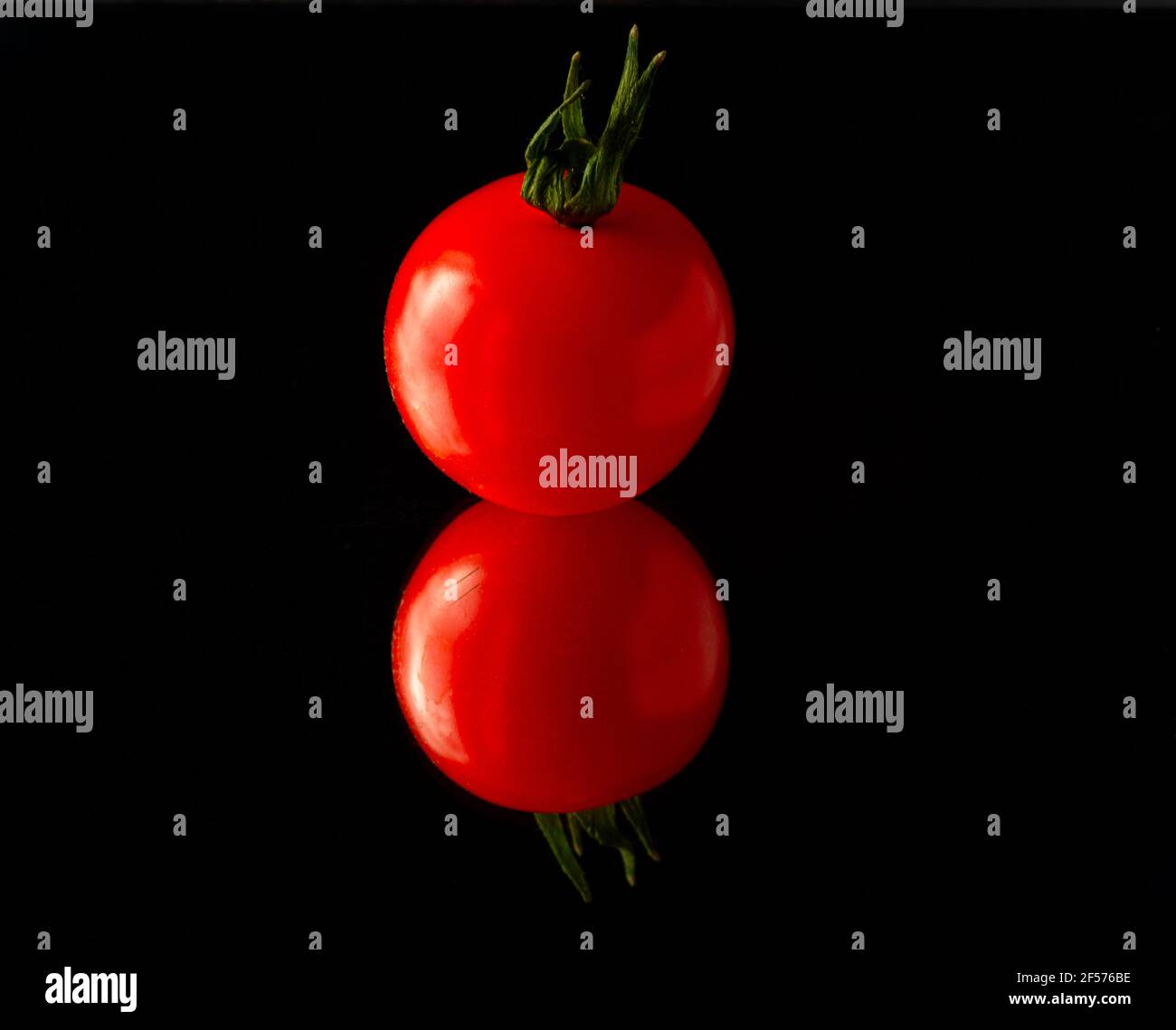 cherry tomato isolated on black background with reflection Stock Photo ...