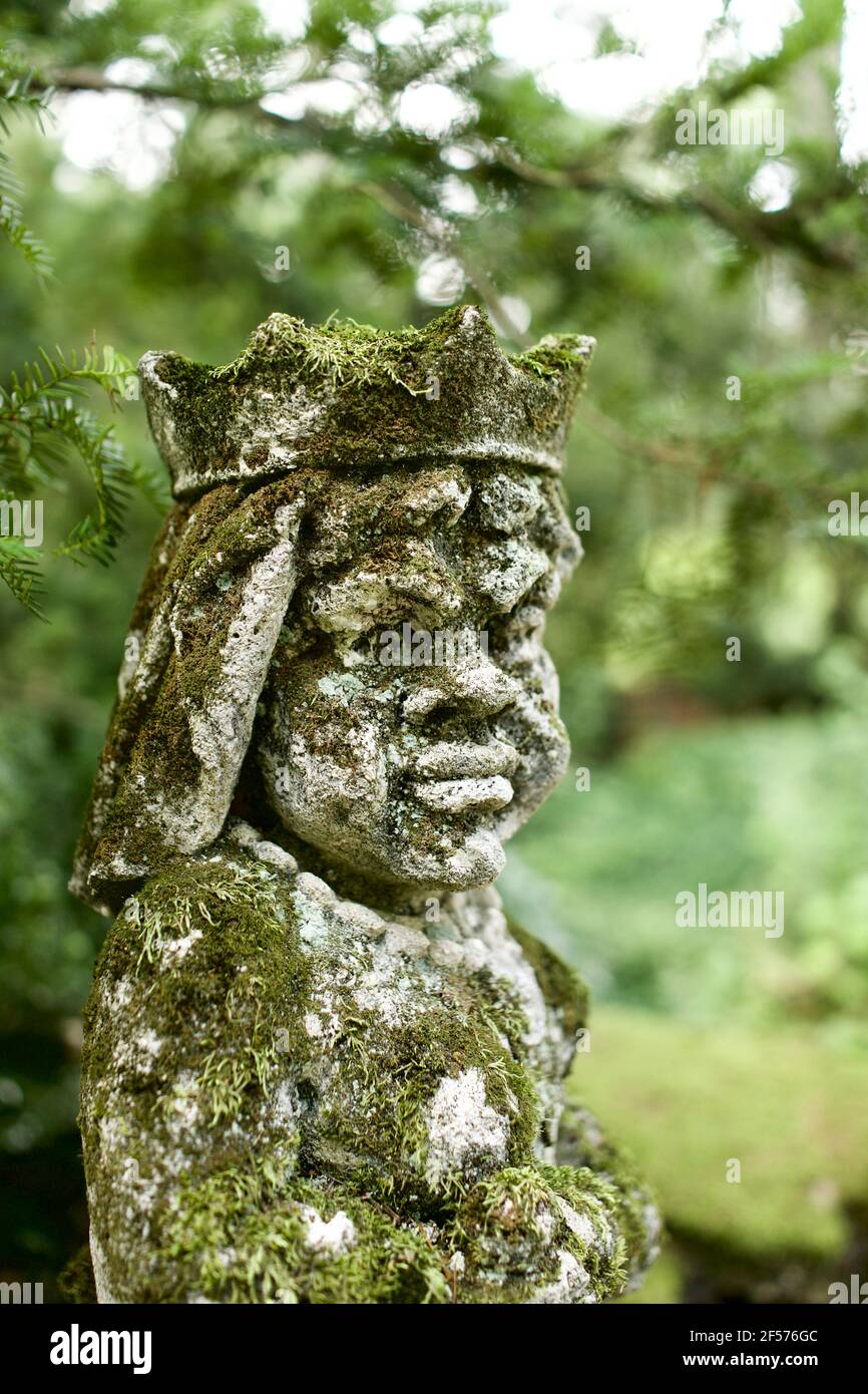 Moss covered statues at Greenwood Gardens in Millburn, NJ, USA. These