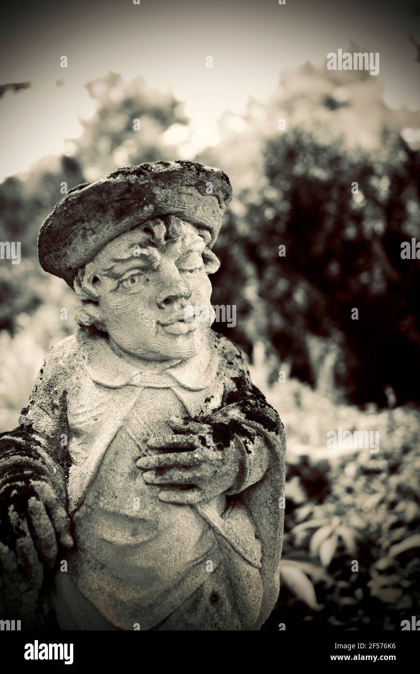 Moss covered statues at Greenwood Gardens in Millburn, NJ, USA.  These are actually large Limestone chess pieces purchased by Peter P. Blanchard Jr. Stock Photo