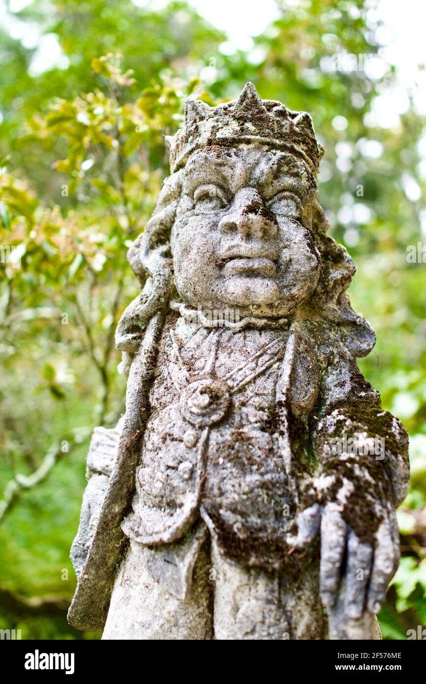 Moss covered statues at Greenwood Gardens in Millburn, NJ, USA.  These are actually large Limestone chess pieces purchased by Peter P. Blanchard Jr. Stock Photo