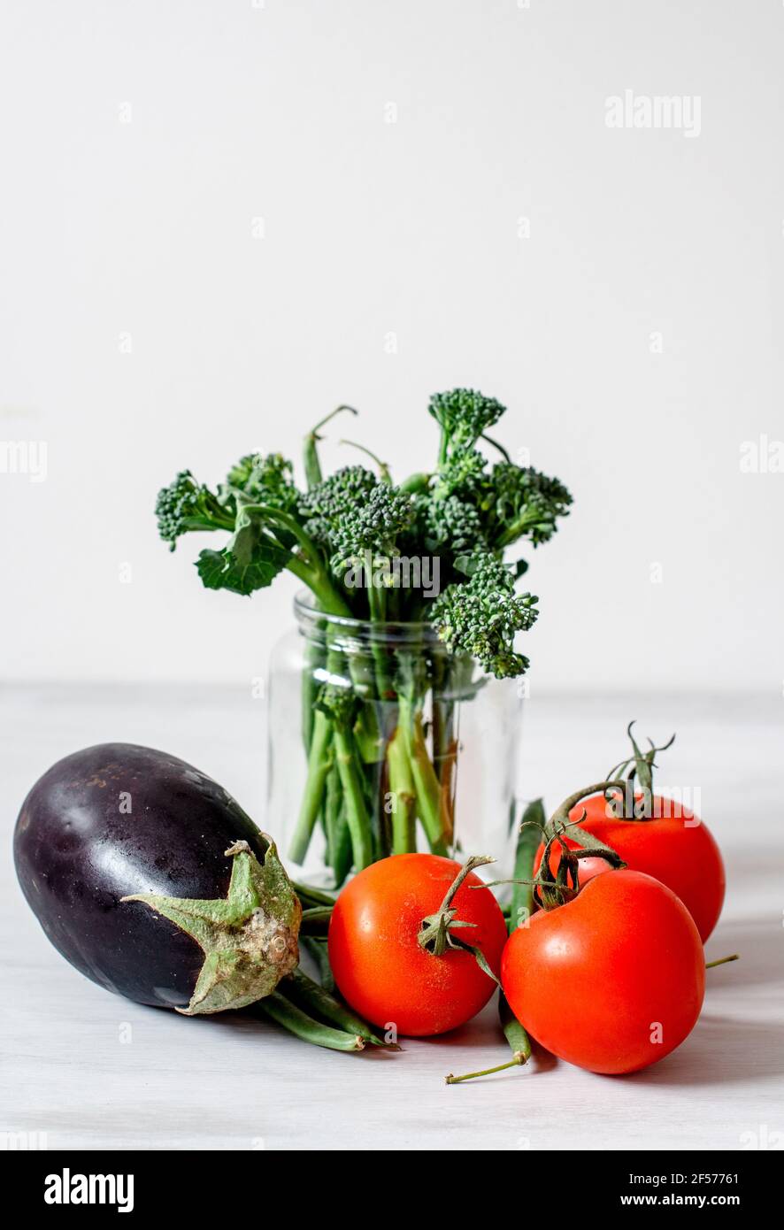Organic Vegetables - Aubergine, Egg plant, Tomatoes, broccoli with a brown paper bag Stock Photo