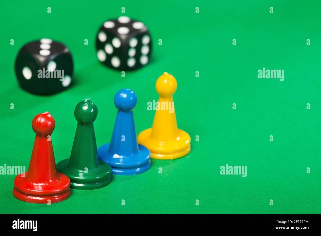 Colorful game pieces and dice Stock Photo - Alamy