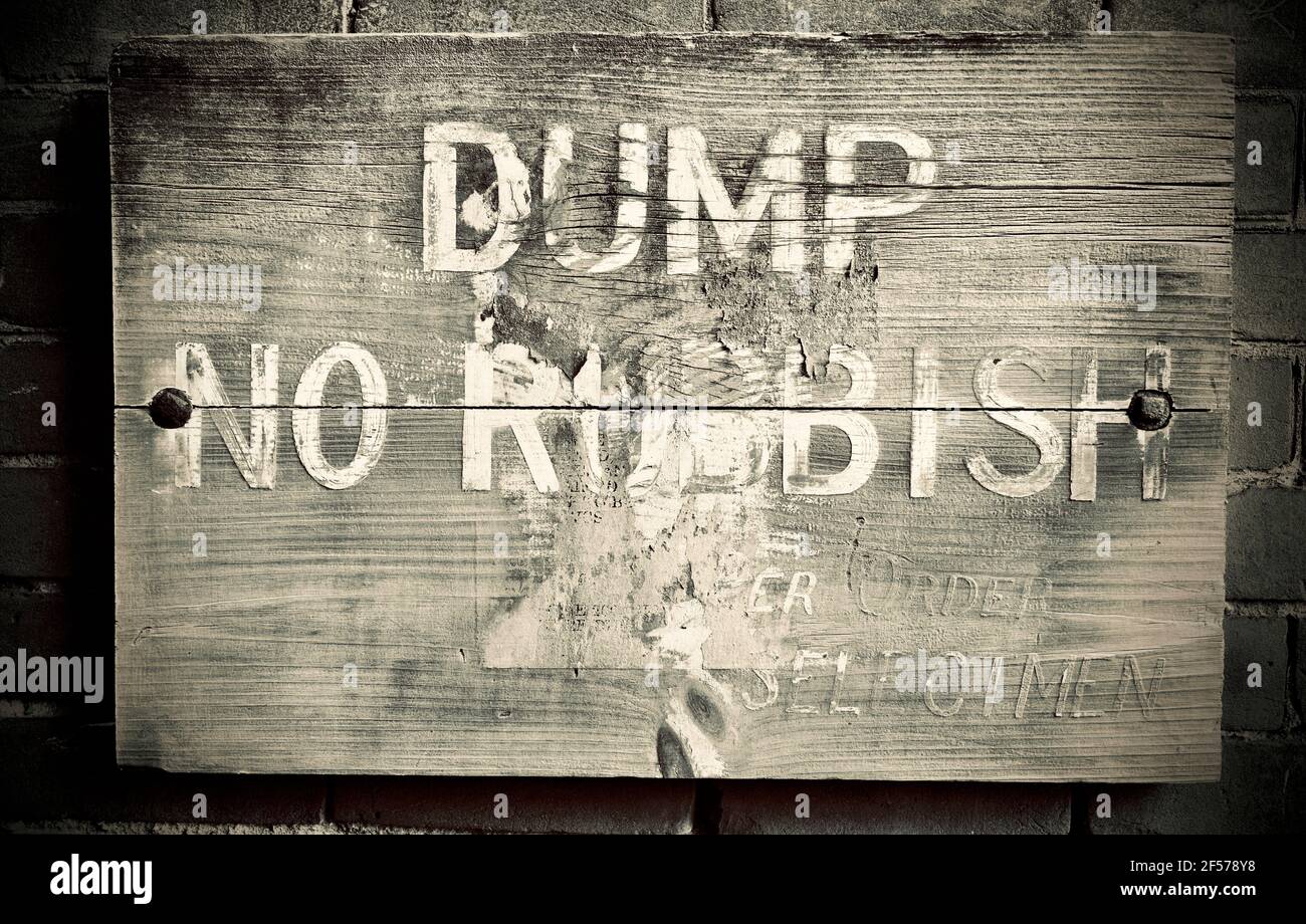 Old weather sign with words, “Dump No Rubbish” by order of Selectmen. Stock Photo