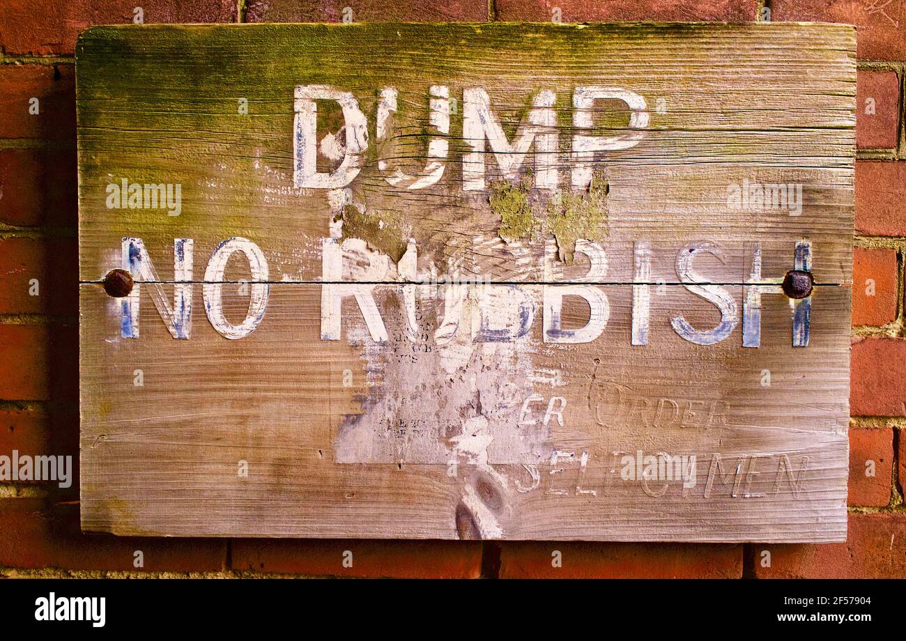 Old weather sign with words, “Dump No Rubbish” by order of Selectmen. Stock Photo