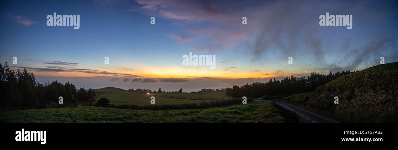 Panorama during sunset at Sao Miguel island, Azores travel destination, view over pastures and the Atlantic ocean. Stock Photo
