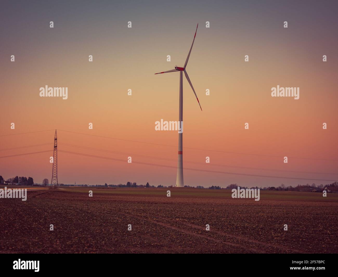 Wind turbine during sunset. Stock Photo