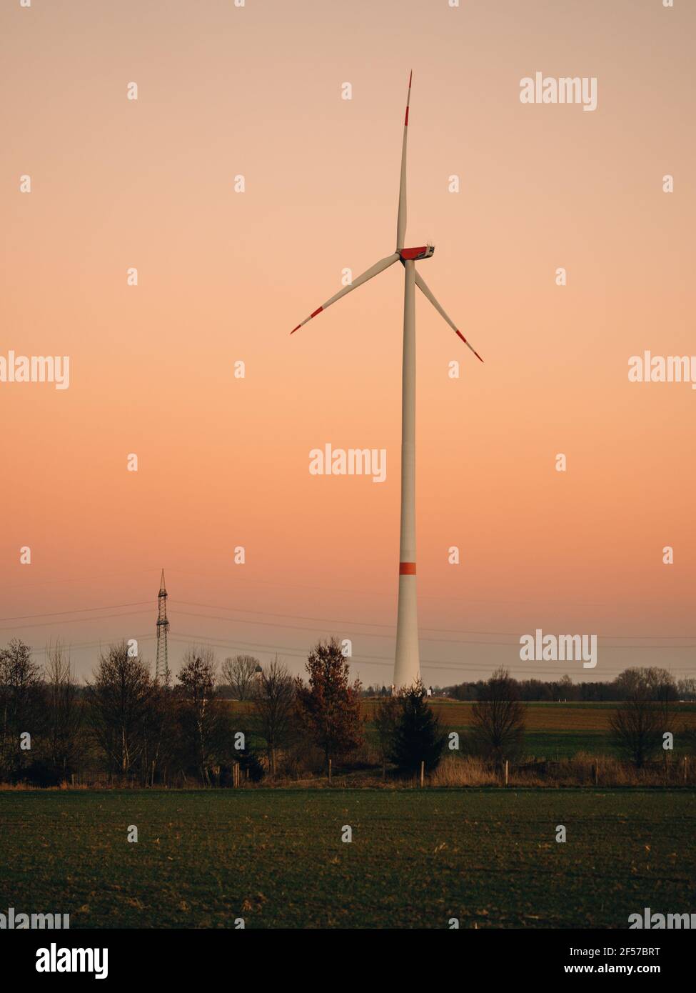 Wind turbine during sunset. Stock Photo