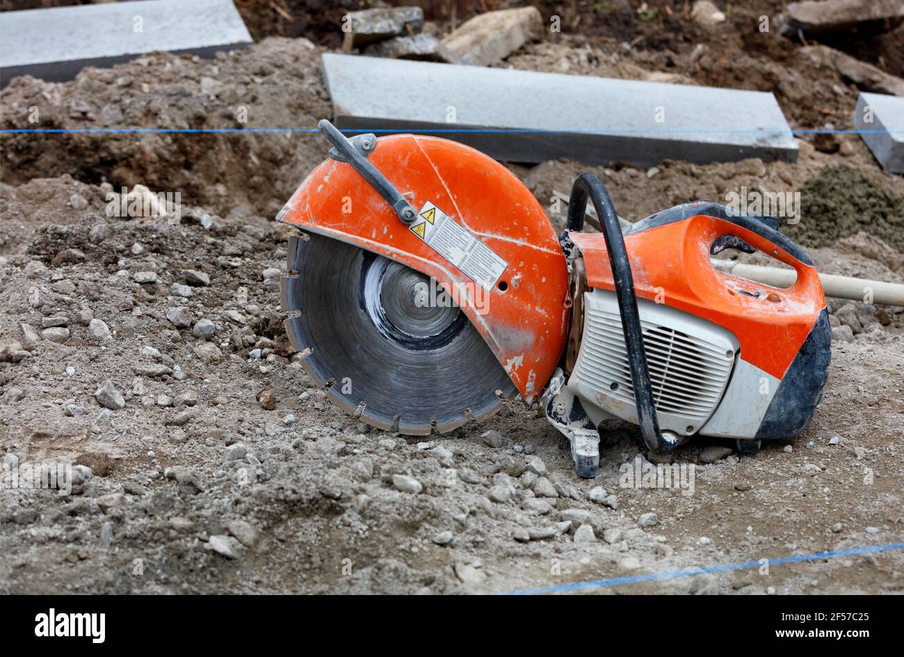 A worn, bright orange petrol saw with a 