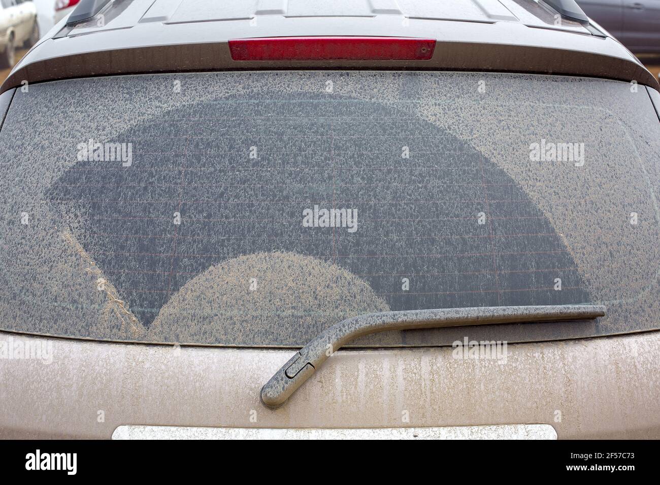 car rear window covered with a layer of swamp after the rain closeup of