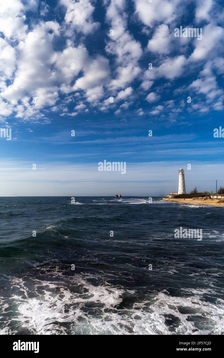 Lone beacon guards the ships. The lighthouse shows the way for boats ...