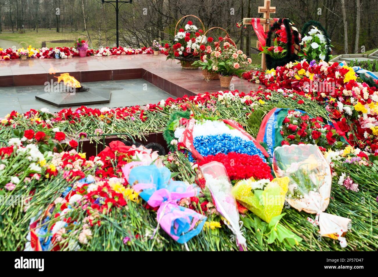 World war memorial with eternal light. A lot of flowers in Victory day at May 9. Petrozavodsk, Russia Stock Photo